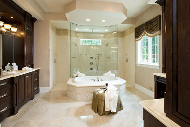 Design ideas for a large classic ensuite bathroom in Philadelphia with recessed-panel cabinets, dark wood cabinets, a built-in bath, a walk-in shower, porcelain tiles, beige walls, porcelain flooring, a submerged sink, marble worktops, beige floors and an open shower.