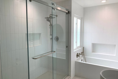 Bathroom - mid-sized contemporary master white tile and porcelain tile porcelain tile and double-sink bathroom idea in Los Angeles with a one-piece toilet, white walls, a vessel sink, quartz countertops, white countertops, a niche and a freestanding vanity