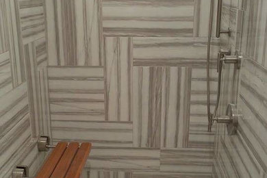 Transitional beige tile, brown tile, gray tile, white tile and ceramic tile ceramic tile alcove shower photo in New York