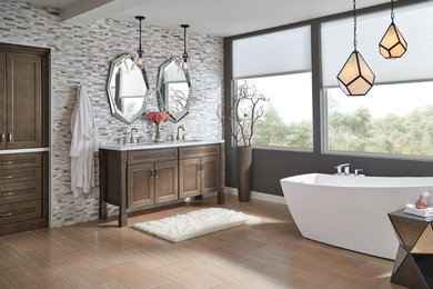 Freestanding bathtub - large modern master beige tile and matchstick tile laminate floor and brown floor freestanding bathtub idea in Other with recessed-panel cabinets, brown cabinets, gray walls, an undermount sink and solid surface countertops