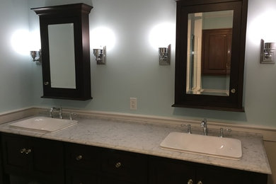 Arts and crafts master porcelain tile and multicolored floor bathroom photo in Other with dark wood cabinets, blue walls, marble countertops, recessed-panel cabinets and an undermount sink