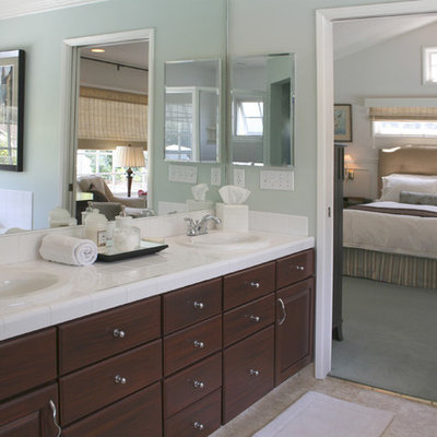 Bathroom - transitional master white tile and porcelain tile bathroom idea in Los Angeles with a drop-in sink, raised-panel cabinets, dark wood cabinets, tile countertops, blue walls and white countertops