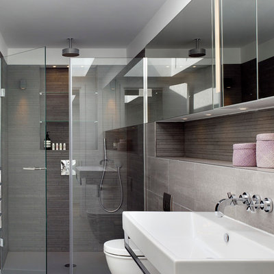 Trendy bathroom photo in London with a wall-mount sink and brown walls