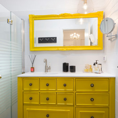 Eclectic white tile walk-in shower photo in Other with furniture-like cabinets, yellow cabinets and white walls