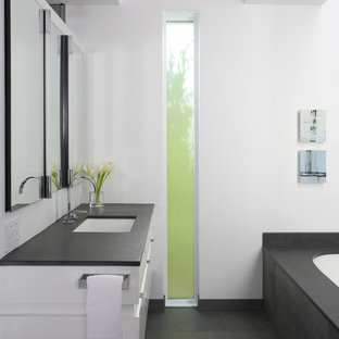 Foto di una stanza da bagno padronale classica di medie dimensioni con ante lisce, ante bianche, vasca sottopiano, piastrelle nere, top in saponaria, pareti bianche, pavimento con piastrelle in ceramica, doccia aperta, pavimento grigio, doccia aperta e top grigio