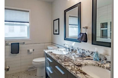 This is an example of a traditional bathroom in Minneapolis with a shower/bath combination, black and white tiles, ceramic tiles, grey walls and vinyl flooring.
