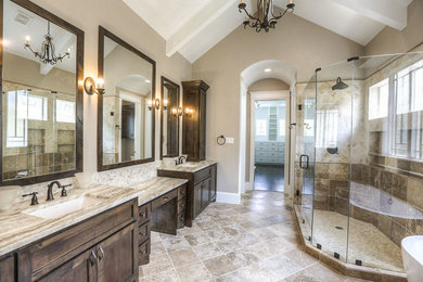 Example of a large arts and crafts master beige tile, brown tile and ceramic tile ceramic tile bathroom design in Houston with recessed-panel cabinets, dark wood cabinets, a two-piece toilet, beige walls and an undermount sink