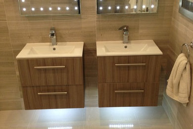 This is an example of a large contemporary ensuite bathroom in Cheshire with medium wood cabinets.