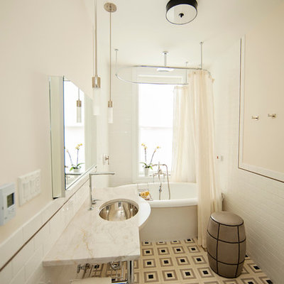 Freestanding bathtub - mid-sized contemporary 3/4 white tile and subway tile linoleum floor freestanding bathtub idea in New York with an undermount sink, marble countertops, a wall-mount toilet and beige walls