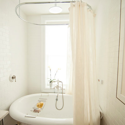 Inspiration for a mid-sized contemporary 3/4 white tile and subway tile linoleum floor bathroom remodel in New York with a wall-mount toilet, marble countertops, beige walls and an undermount sink