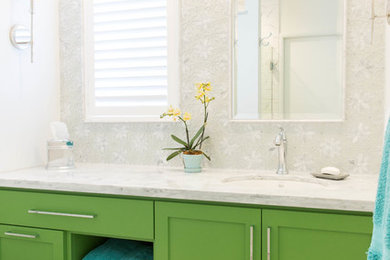 Bathroom - mosaic tile bathroom idea in Other with recessed-panel cabinets, green cabinets, a wall-mount toilet, an undermount sink and marble countertops