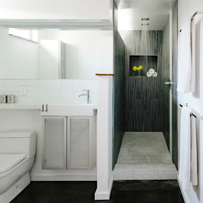 Inspiration for a modern gray tile and glass tile bathroom remodel in Portland with glass-front cabinets