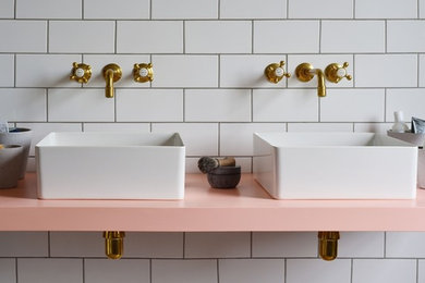 Inspiration for a medium sized classic family bathroom in London with raised-panel cabinets, medium wood cabinets, a claw-foot bath, a walk-in shower, a one-piece toilet, white tiles, ceramic tiles, white walls, ceramic flooring, a trough sink, solid surface worktops, multi-coloured floors and an open shower.