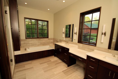 Example of a large minimalist master beige tile and ceramic tile ceramic tile bathroom design in Indianapolis with a drop-in sink, flat-panel cabinets, dark wood cabinets, laminate countertops and beige walls
