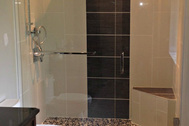 Example of a mid-sized trendy master gray tile and porcelain tile porcelain tile double shower design in Vancouver with an undermount sink, shaker cabinets, dark wood cabinets, granite countertops and gray walls