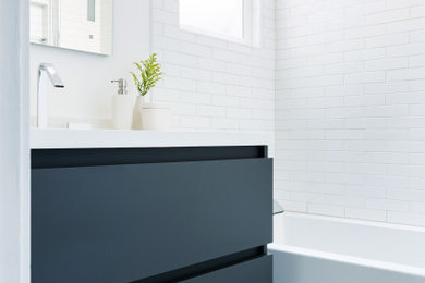 Example of a small minimalist 3/4 white tile and subway tile mosaic tile floor, gray floor and single-sink bathroom design in San Francisco with flat-panel cabinets, black cabinets, a one-piece toilet, white walls, an undermount sink, quartz countertops, white countertops, a niche and a freestanding vanity