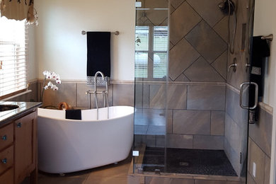 Bathroom - large contemporary master brown tile and ceramic tile ceramic tile and brown floor bathroom idea in Austin with shaker cabinets, medium tone wood cabinets, beige walls, an undermount sink and a hinged shower door