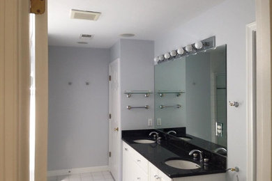 Example of a mid-sized transitional 3/4 ceramic tile and white floor bathroom design in Orange County with raised-panel cabinets, white cabinets, gray walls, an undermount sink and granite countertops