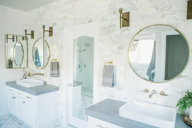 Bathroom - mid-sized transitional master multicolored tile and marble tile marble floor and double-sink bathroom idea in Orange County with shaker cabinets, white cabinets, white walls, a vessel sink, a hinged shower door, gray countertops and a built-in vanity