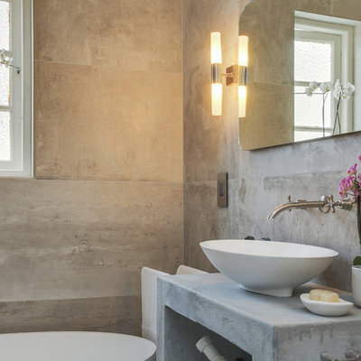 Inspiration for a small contemporary 3/4 gray tile and cement tile concrete floor freestanding bathtub remodel in Other with gray walls and concrete countertops