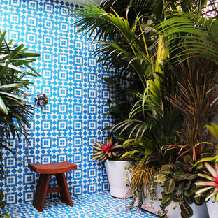 Inspiration for a tropical blue tile bathroom remodel in Los Angeles
