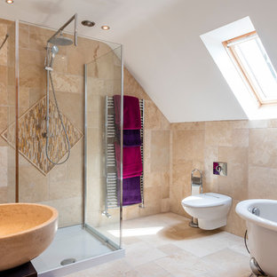 This is an example of a medium sized mediterranean bathroom in Other with a freestanding bath, a corner shower, a wall mounted toilet, beige tiles, beige walls, a vessel sink, beige floors and black worktops.