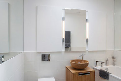 Family bathroom in Essex with freestanding cabinets.
