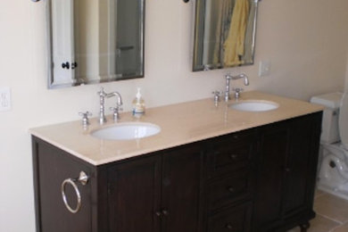 Minimalist beige tile and ceramic tile ceramic tile bathroom photo in Portland Maine with raised-panel cabinets, dark wood cabinets and beige walls