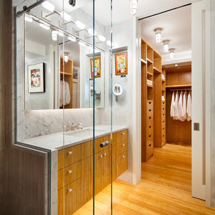 Small contemporary master bathroom in New York with flat-panel cabinets, medium wood cabinets, white tile, stone slab, an undermount sink, an open shower, a wall-mount toilet, bamboo floors, marble benchtops, white walls and a sliding shower screen.
