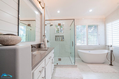 Large minimalist master white tile and marble tile marble floor and white floor bathroom photo in Los Angeles with shaker cabinets, white cabinets, white walls, an undermount sink, a hinged shower door and brown countertops