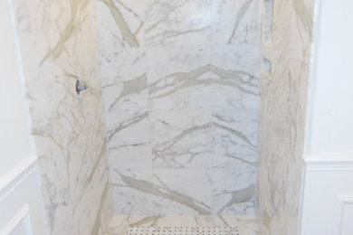 Small trendy white tile and stone tile mosaic tile floor doorless shower photo in Orange County