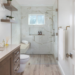 Inspiration for a transitional 3/4 multicolored tile wood-look tile floor, brown floor and single-sink bathroom remodel in Orange County with beaded inset cabinets, medium tone wood cabinets, white walls, an undermount sink, a hinged shower door, beige countertops, a niche and a built-in vanity
