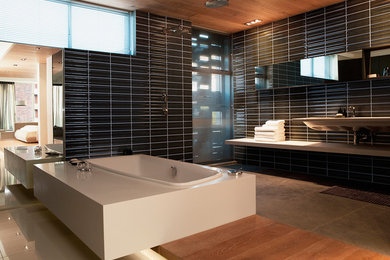 Photo of a contemporary bathroom in London with red tiles and porcelain tiles.