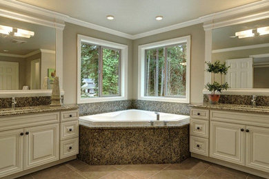 Example of a large classic master beige tile ceramic tile and gray floor corner bathtub design in Chicago with raised-panel cabinets, white cabinets, beige walls, an undermount sink and granite countertops