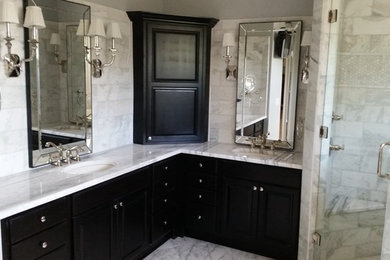 Photo of a medium sized classic ensuite half tiled bathroom in Tampa with recessed-panel cabinets, black cabinets, a built-in bath, a corner shower, grey tiles, marble tiles, grey walls, marble flooring, a submerged sink, marble worktops, grey floors and a hinged door.