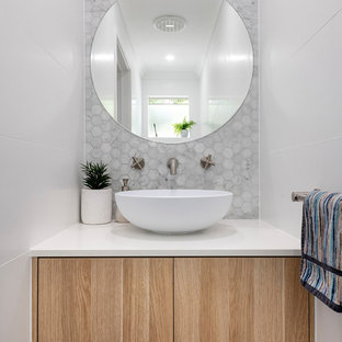 This is an example of a contemporary bathroom in Perth with flat-panel cabinets, light wood cabinets, white tile, mosaic tile, white walls, a vessel sink and white benchtops.