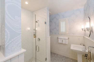 Example of a classic white tile and porcelain tile marble floor bathroom design in Austin with blue walls