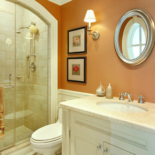 Mid-sized traditional 3/4 bathroom in Toronto with stone tile, orange walls, white cabinets, an alcove shower, a one-piece toilet, porcelain floors, an undermount sink, marble benchtops and recessed-panel cabinets.