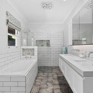 Inspiration for a transitional master bathroom in Brisbane with shaker cabinets, white cabinets, a drop-in tub, a curbless shower, white tile, subway tile, grey walls, an undermount sink, grey floor, an open shower and grey benchtops.