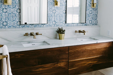 Large trendy master blue tile and cement tile marble floor and white floor double shower photo in Baltimore with flat-panel cabinets, dark wood cabinets, a one-piece toilet, blue walls, a drop-in sink, quartz countertops, a hinged shower door and white countertops