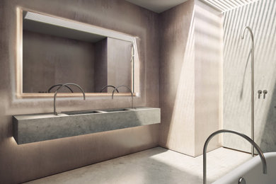 Imagen de cuarto de baño moderno con puertas de armario grises, bañera exenta, suelo de cemento y suelo gris