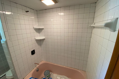 Small arts and crafts master gray tile and ceramic tile cement tile floor, multicolored floor and single-sink bathroom photo in Milwaukee with raised-panel cabinets, a one-piece toilet, pink walls, a drop-in sink, tile countertops, pink countertops and a built-in vanity