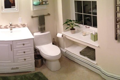 Large trendy master beige tile and pebble tile porcelain tile bathroom photo in Portland Maine with white cabinets, a one-piece toilet and beige walls