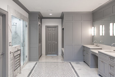 Inspiration for a large transitional master white tile and marble tile marble floor and white floor bathroom remodel in Cleveland with recessed-panel cabinets, white cabinets, white walls, an undermount sink, a hinged shower door and white countertops