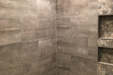 Inspiration for a rustic master gray tile and porcelain tile porcelain tile and black floor bathroom remodel in Minneapolis with shaker cabinets, light wood cabinets, a one-piece toilet, gray walls, an undermount sink and quartz countertops