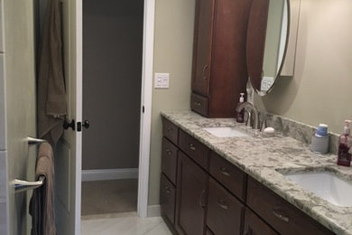 Example of a mid-sized transitional master porcelain tile and beige floor bathroom design in Detroit with flat-panel cabinets, dark wood cabinets and quartz countertops