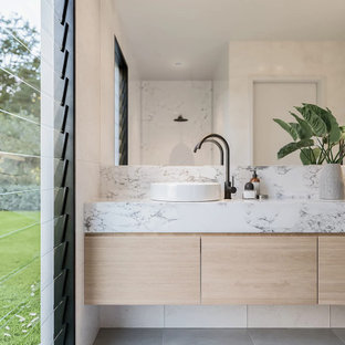Inspiration for a mid-sized contemporary master bathroom in Perth with flat-panel cabinets, light wood cabinets, an open shower, white tile, ceramic tile, white walls, ceramic floors, a vessel sink, marble benchtops, grey floor, an open shower and white benchtops.