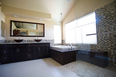 Drop-in bathtub - modern drop-in bathtub idea in San Diego with a vessel sink