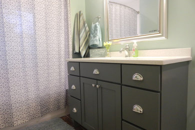 Mid-sized transitional kids' white tile and ceramic tile ceramic tile bathroom photo in Milwaukee with flat-panel cabinets, green cabinets, a two-piece toilet, green walls, an undermount sink and granite countertops