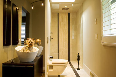 Example of a small trendy 3/4 beige tile and stone tile marble floor walk-in shower design in Minneapolis with a vessel sink, flat-panel cabinets, dark wood cabinets, wood countertops, a wall-mount toilet and beige walls